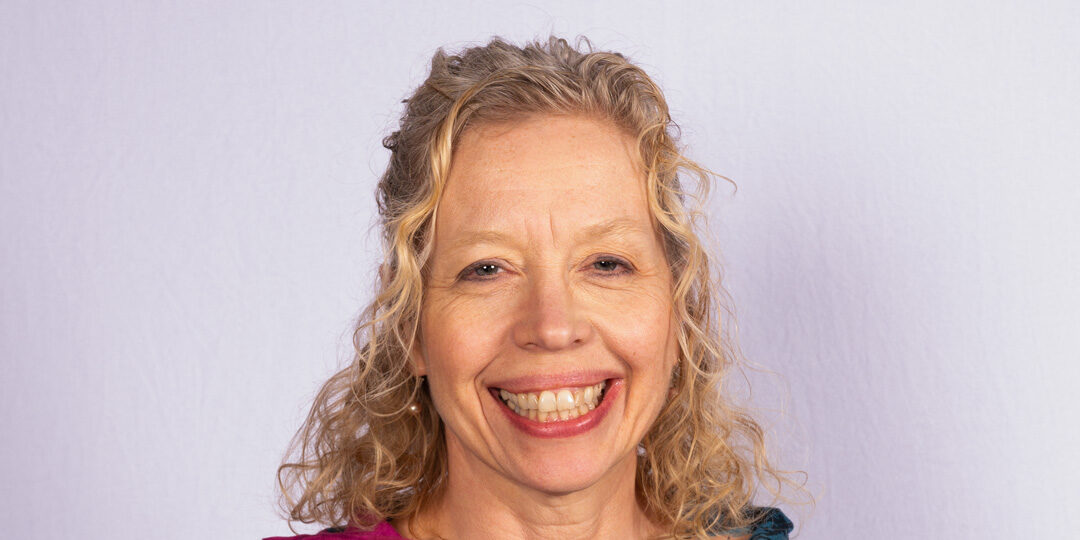 Woman with blonde curly hair and smile