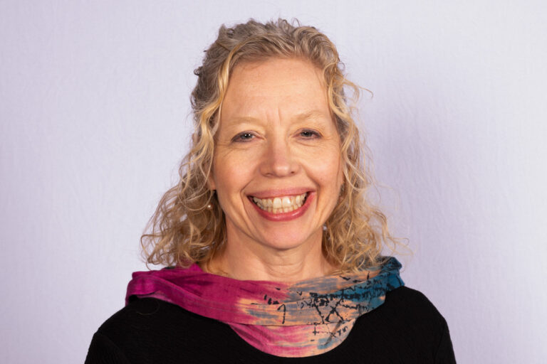 Woman with blonde curly hair and smile