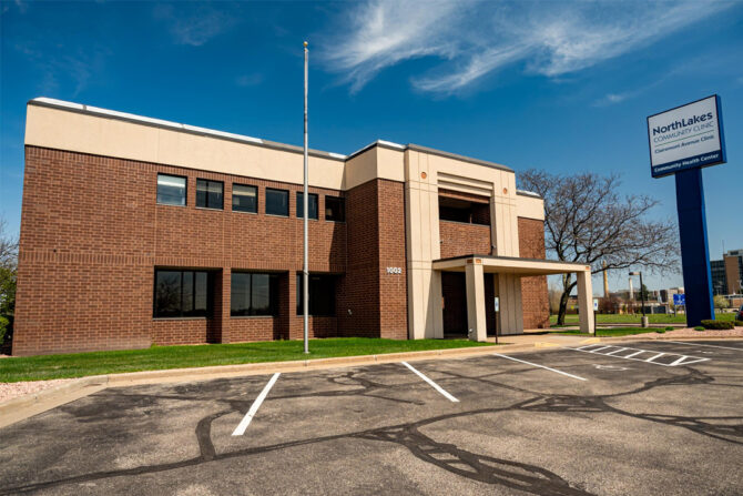 Outside of large brick building with flag pole and tall NorthLakes sign out front
