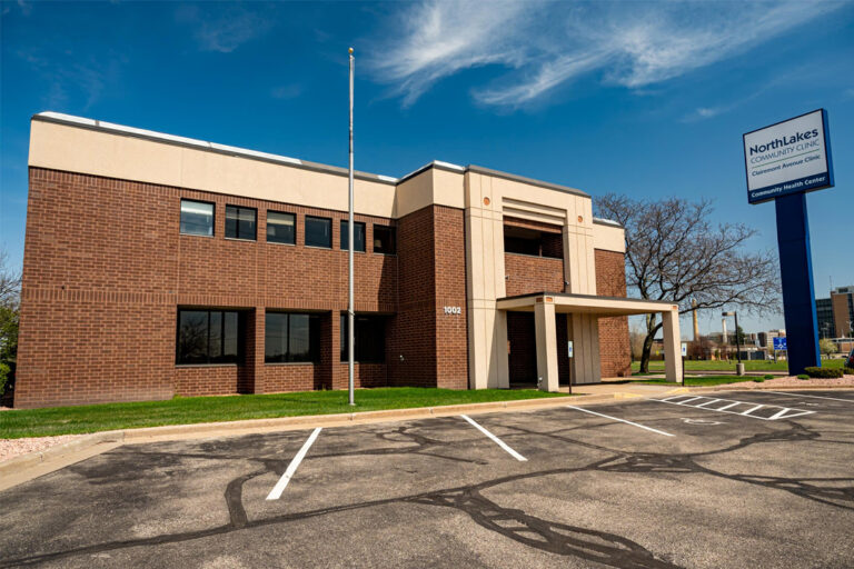 Outside of large brick building with flag pole and tall NorthLakes sign out front