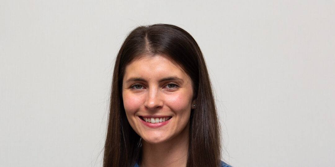 Headshot of a woman with long, straight dark hair