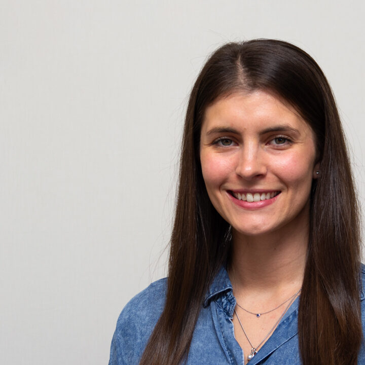 Samantha-Barg-Featured-Image Headshot of a woman with long, straight dark hair