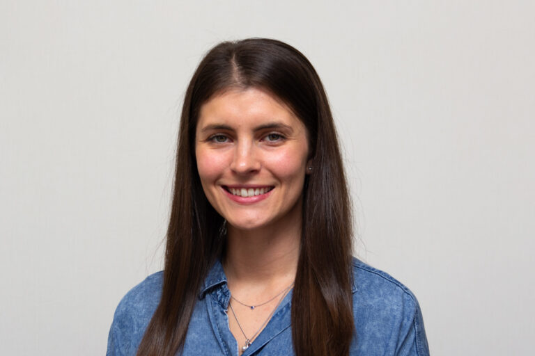 Headshot of a woman with long, straight dark hair