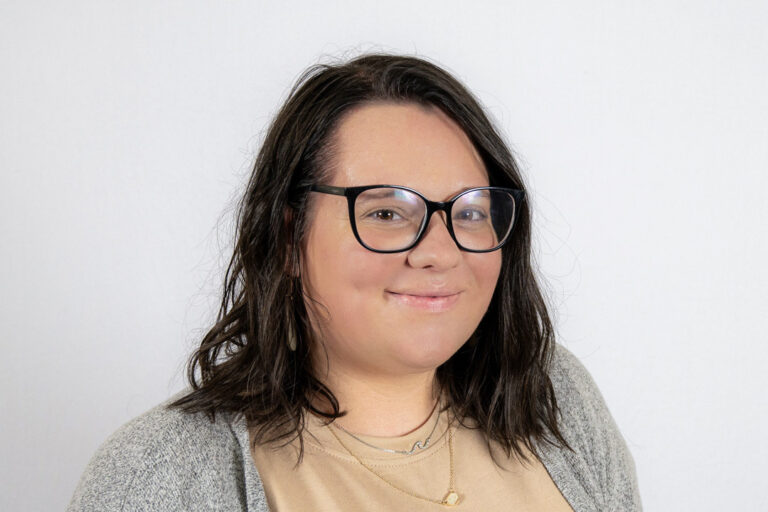Headshot of woman with short dark hair and glasses