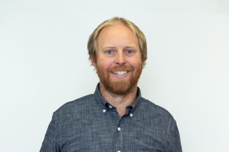 Headshot of man with blonde hair and beard