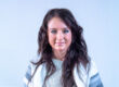 Headshot of woman with very long dark hair and a cardigan