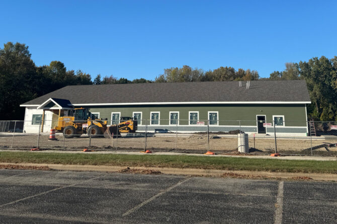 NorthLakes-Recieves-Multiple-Grants-To-Bridge-Gaps-In-Oconto Construction outside of large green building