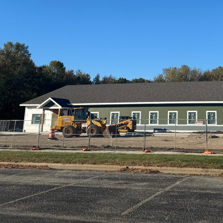 NorthLakes-Recieves-Multiple-Grants-To-Bridge-Gaps-In-Oconto Construction outside of large green building