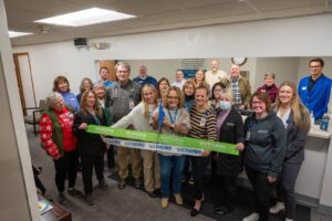 group celebrating a ribbon cutting in a health clinic