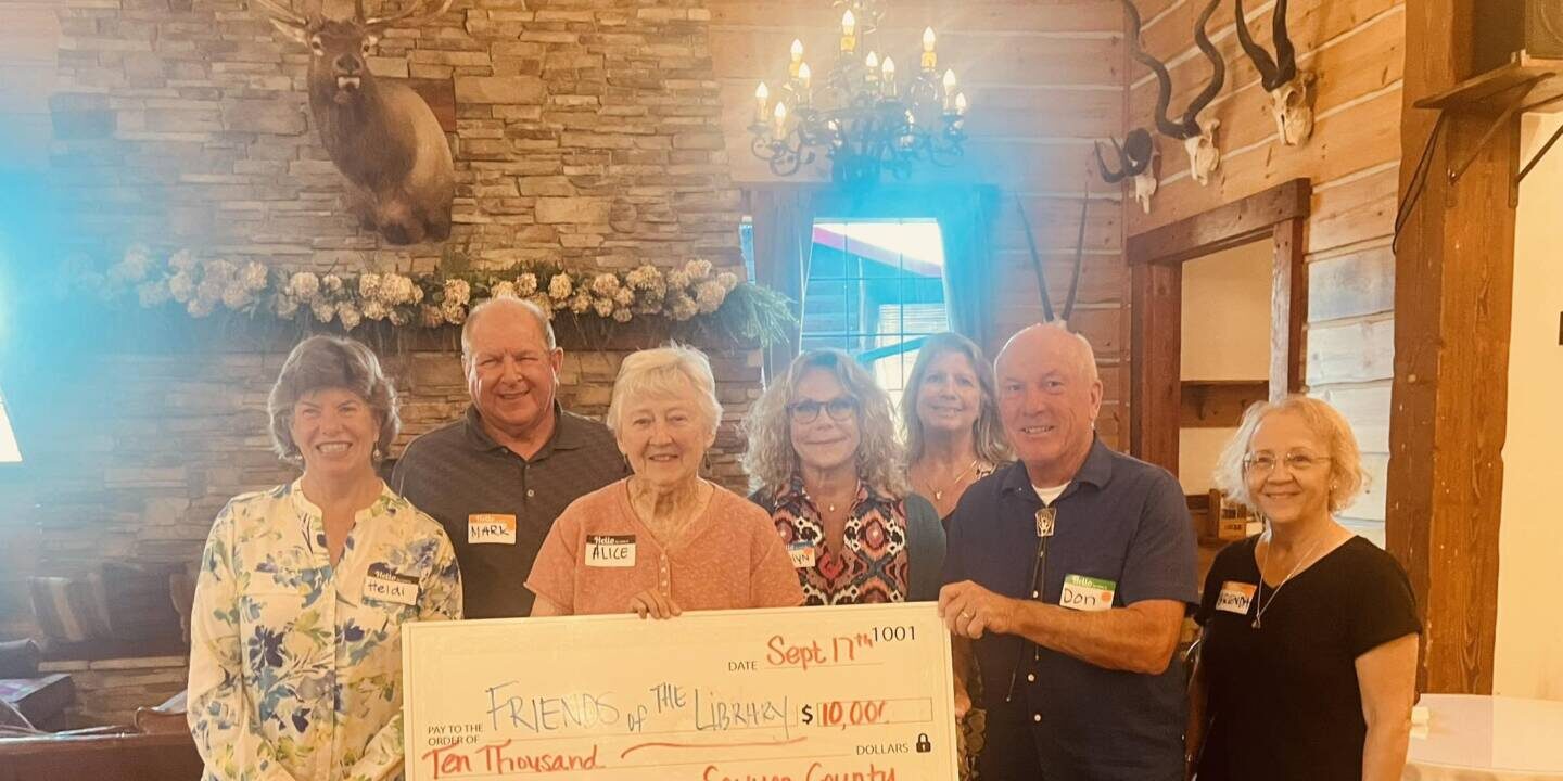 Sawyer Group of men and women holding a check for $10,000