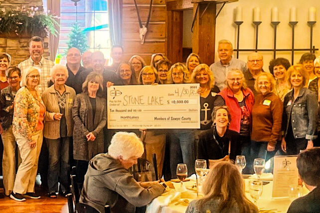 group photo with people holding large check