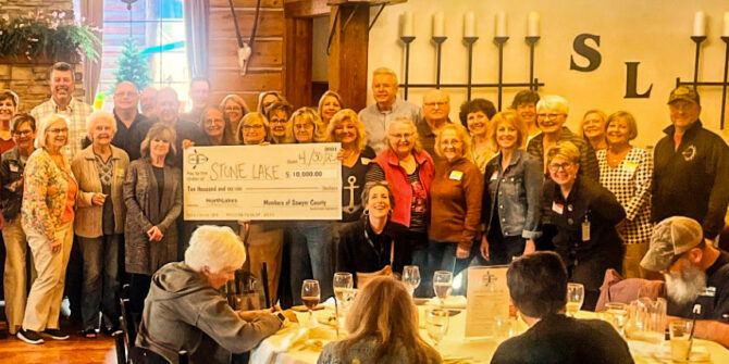 NorthLakes Sawyer Co Giving group photo with people holding large check