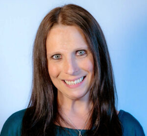 Headshot in blue toned studio lighting of woman with long brown hair