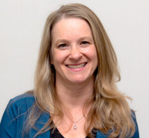 Headshot of woman smiling with long blonde hair 