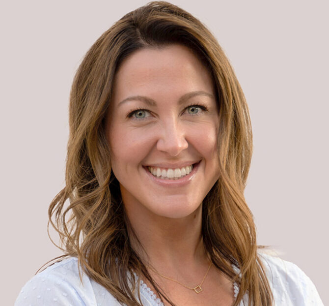 Headshot of woman with light brown curled hair