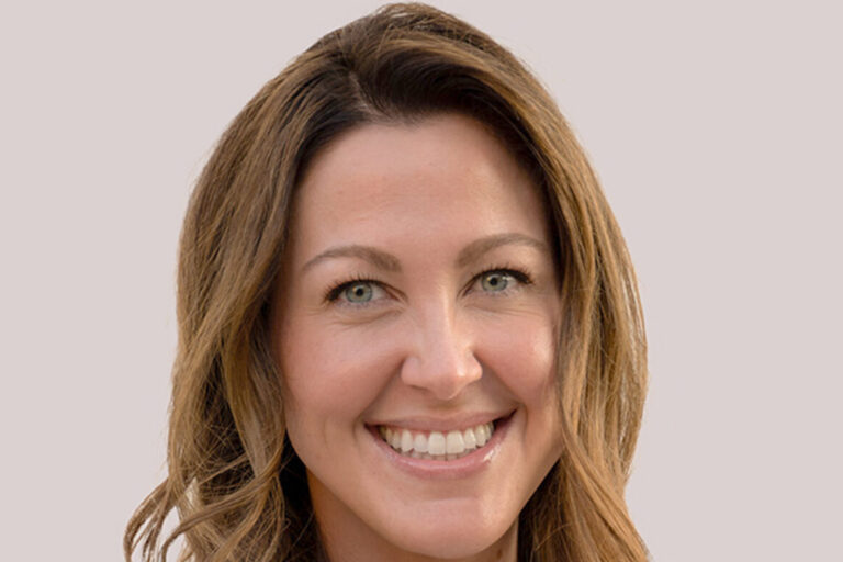 Headshot of woman with light brown curled hair