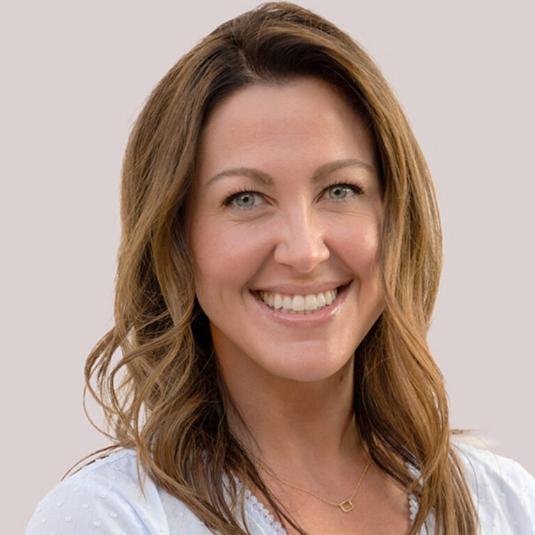 Headshot of woman with light brown curled hair