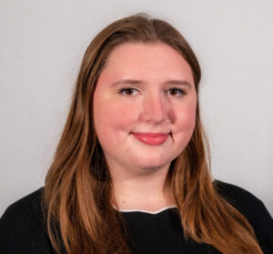 Headshot of woman with black shirt and long hair