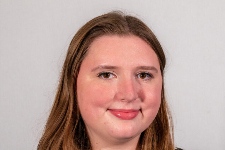 Headshot of woman with black shirt and long hair