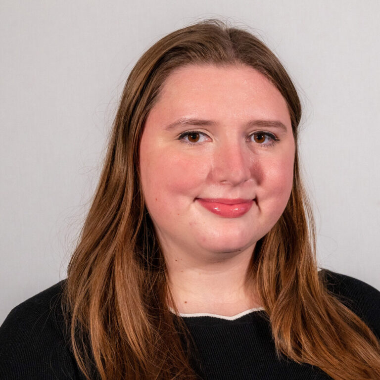 Headshot of woman with black shirt and long hair