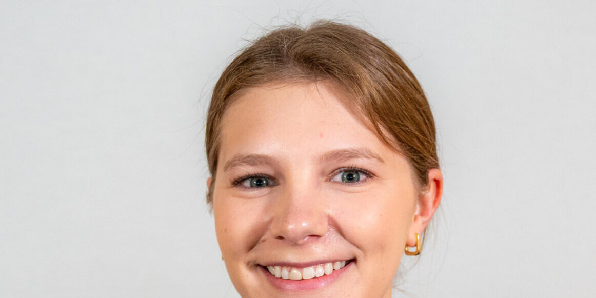headshot of woman in black turtleneck