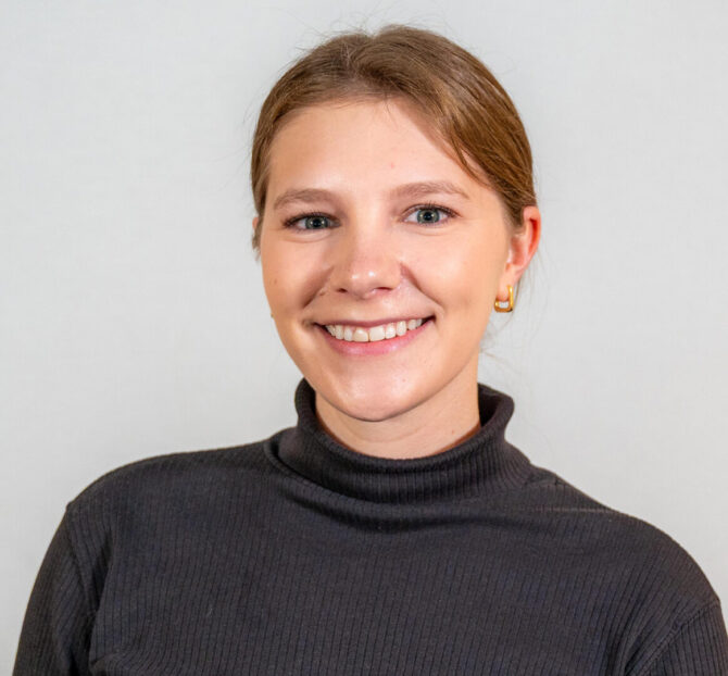 headshot of woman in black turtleneck