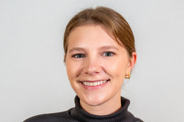 headshot of woman in black turtleneck