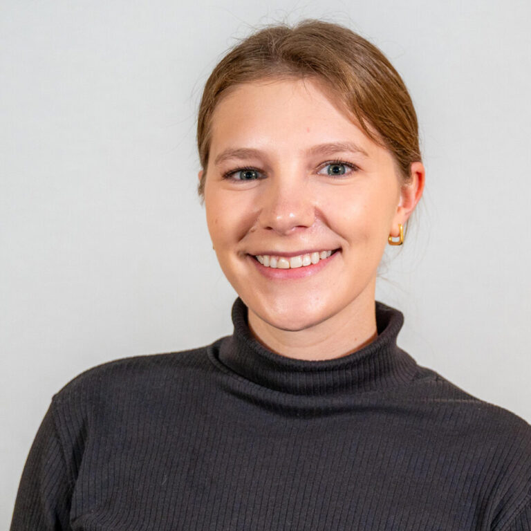headshot of woman in black turtleneck
