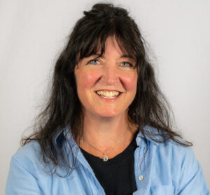 Woman with black hair smiling in headshot