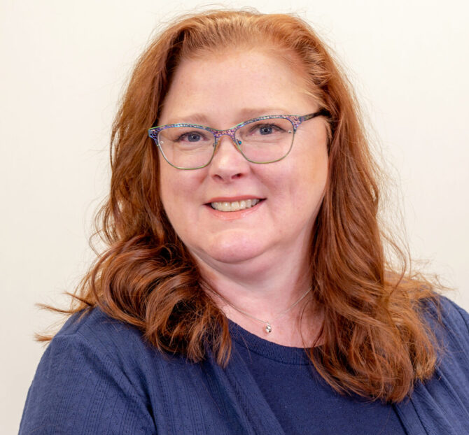 Woman with glasses and blue shirt