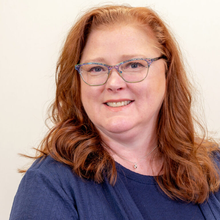 Woman with glasses and blue shirt