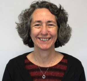 Woman with short hair smiling wearing striped shirt