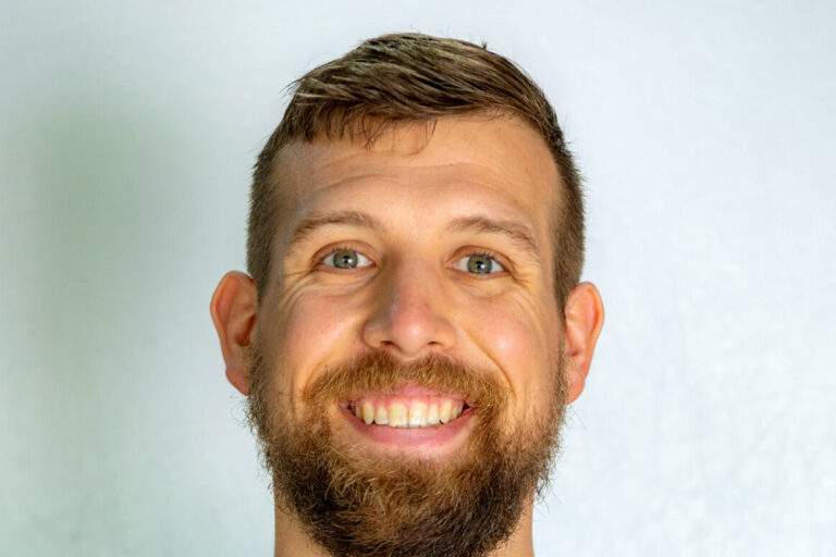 Man with brown short hair and beard