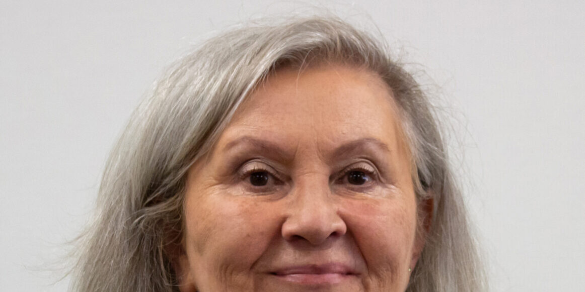 Woman with short hair and black and white plaid shirt