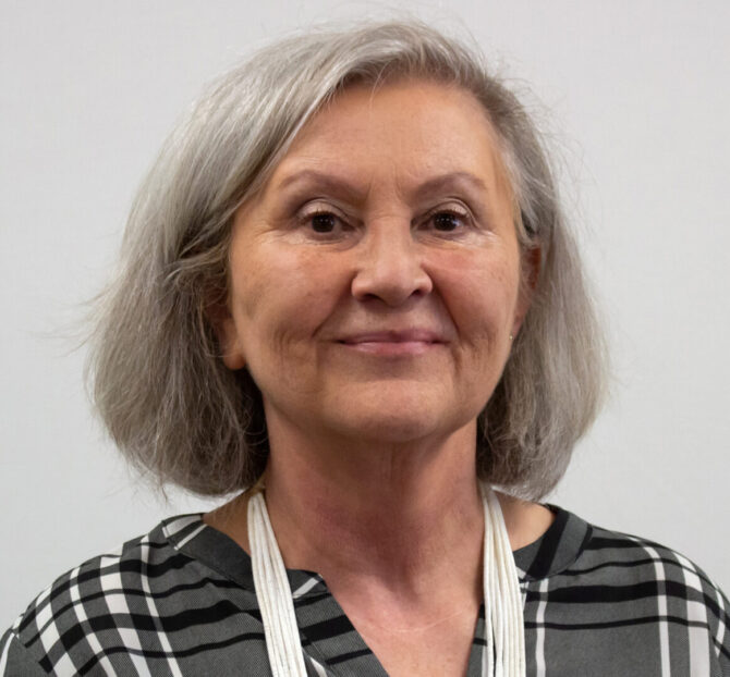 Woman with short hair and black and white plaid shirt