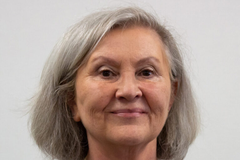 Woman with short hair and black and white plaid shirt