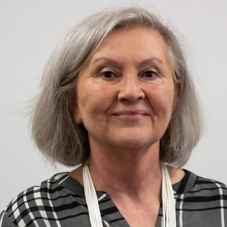 Woman with short hair and black and white plaid shirt