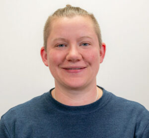 Headshot of provider smiling wearing navy blue long sleeved shirt