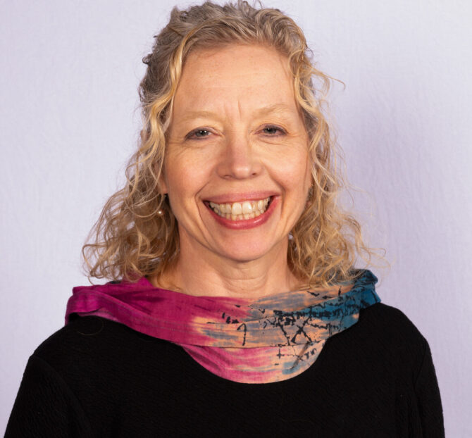 Woman with blonde curly hair and scarf