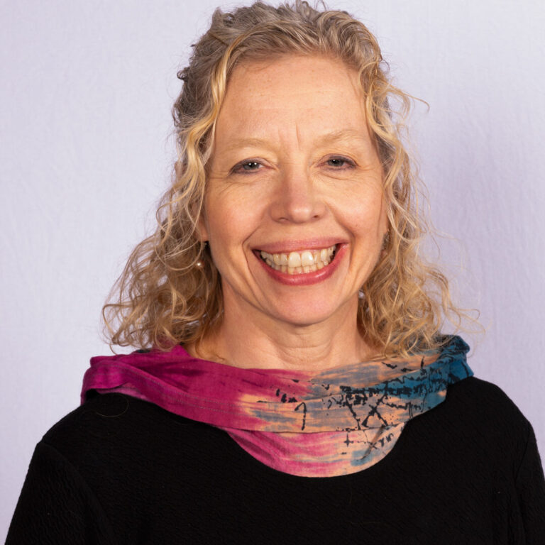 Woman with blonde curly hair and scarf