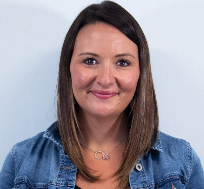 Woman with straight brown hair, brown eyes, and jean jacket