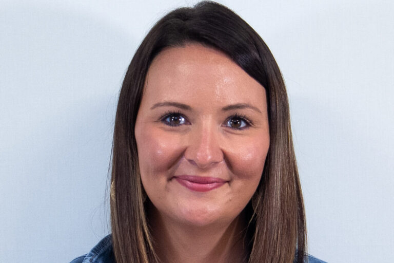 Woman with straight brown hair, brown eyes, and jean jacket