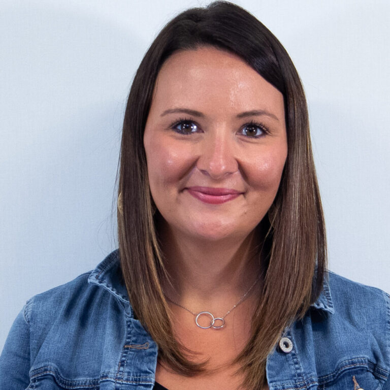 Woman with straight brown hair, brown eyes, and jean jacket