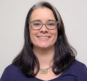 Headshot of woman with black hair and glasses