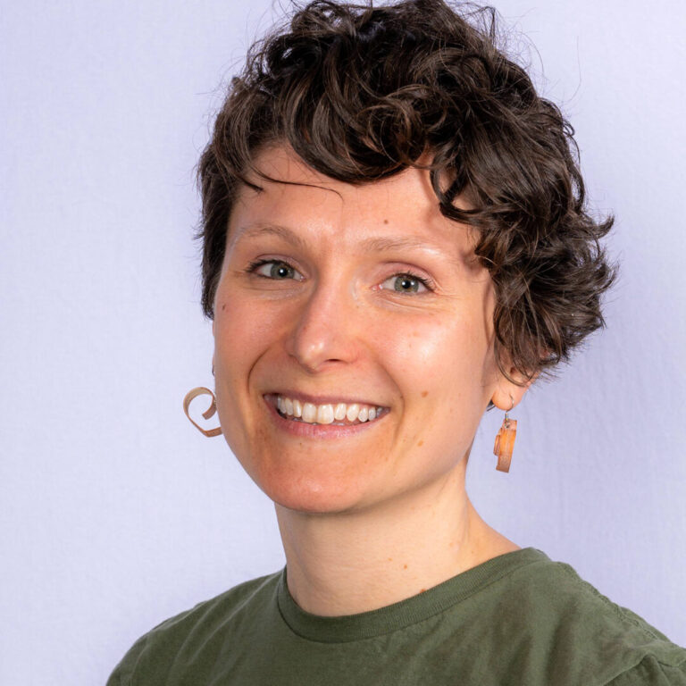 Woman with short curly hair and hazel eyes