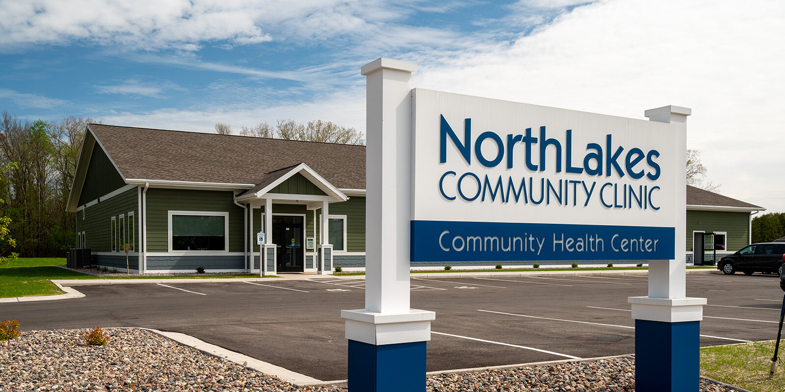 Green building with NorthLakes Community clinic sign in front