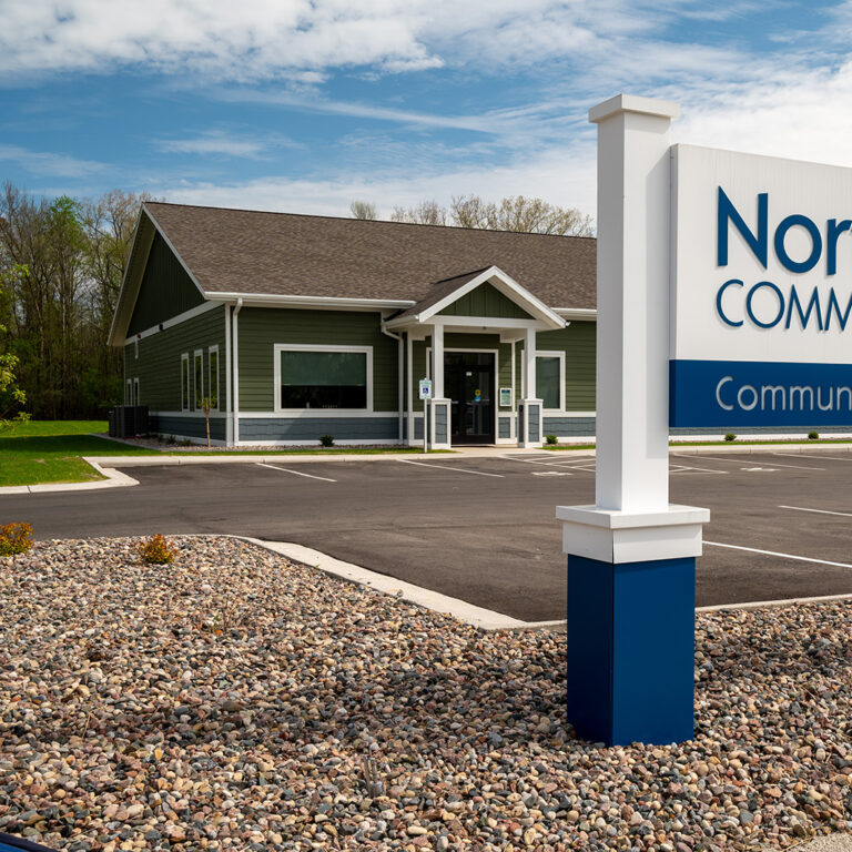 Green building with NorthLakes Community clinic sign in front