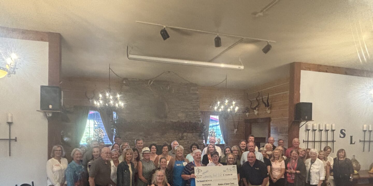 large group in restaurant holding check