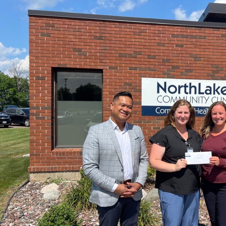 NorthLakes Lending Closet ECFund 1 Three people in front of brick facade outside posing