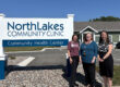 three women in front of sign outside
